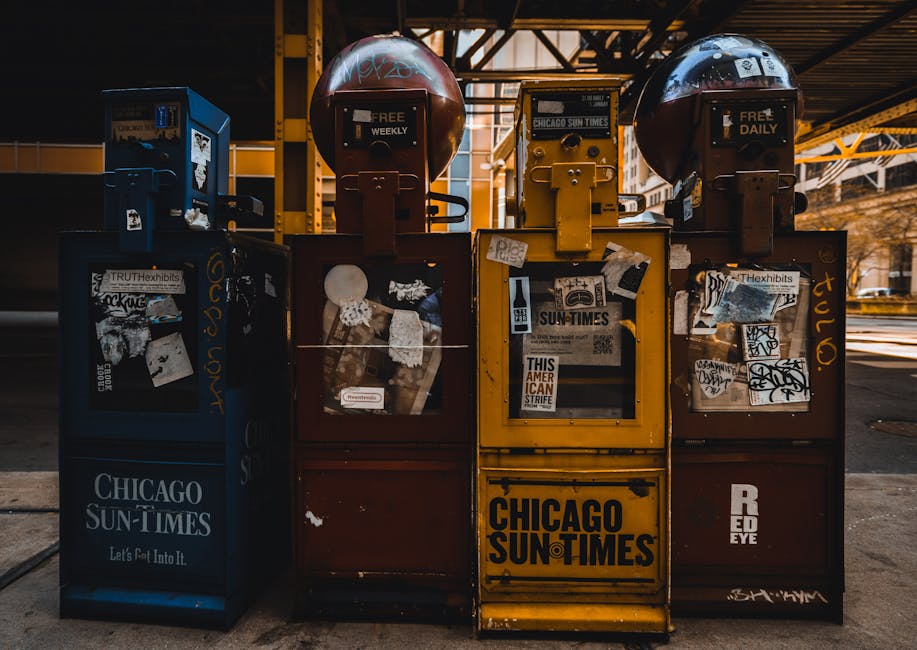 Vintage newspaper vending machines in urban Chicago setting, daytime shot.
